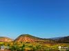我穿越西秦岭、盐关、石峡，来到西和县西高山以西的仇池山。这里山大沟深，崖多梁多，弯路多。特别是攀登仇池山唯一的一条路，行走在悬臂的路上，就像在云雾里穿行。山上的村庄已经被油菜花包围，一湾湾的金黄色，一片片的绿油油麦田被春风吹拂着。绿树下的白房子、园子里的山桃花构成乡村春多姿多彩的图画。我在一个村庄的平台上，观赏全景的时候。四面绝壁的仇池山，居住着古老民族遗留下来的后人，耕耘播种，生儿育女，上山下山，延续了多少代时光和岁月。我不停地按动快门，生怕把美好的风景忘记了。赶了一天的山路，我已经很累了，已经到了下午